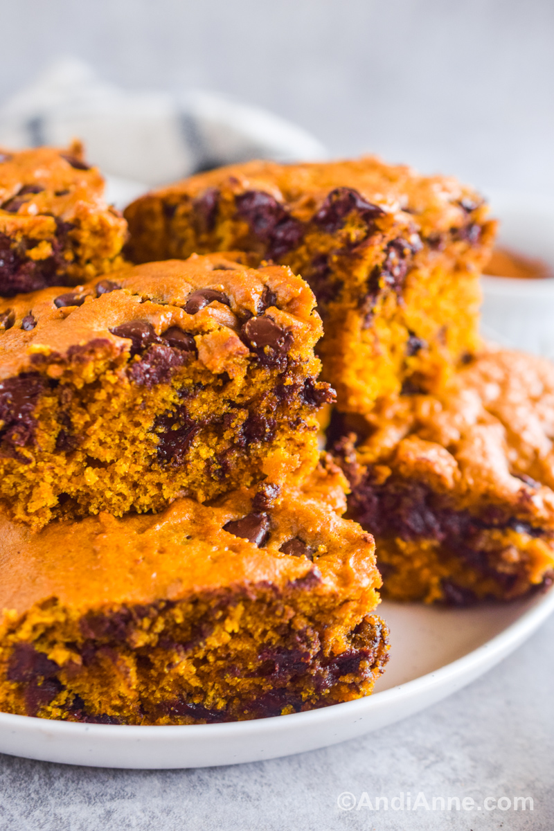 Close up of pumpkin chocolate chip bars piled on top of eachother.