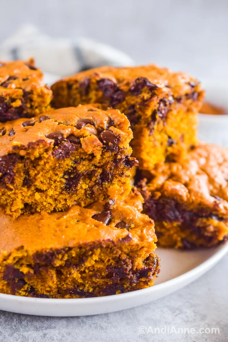 Close up of pumpkin chocolate chip bars piled on top of eachother.