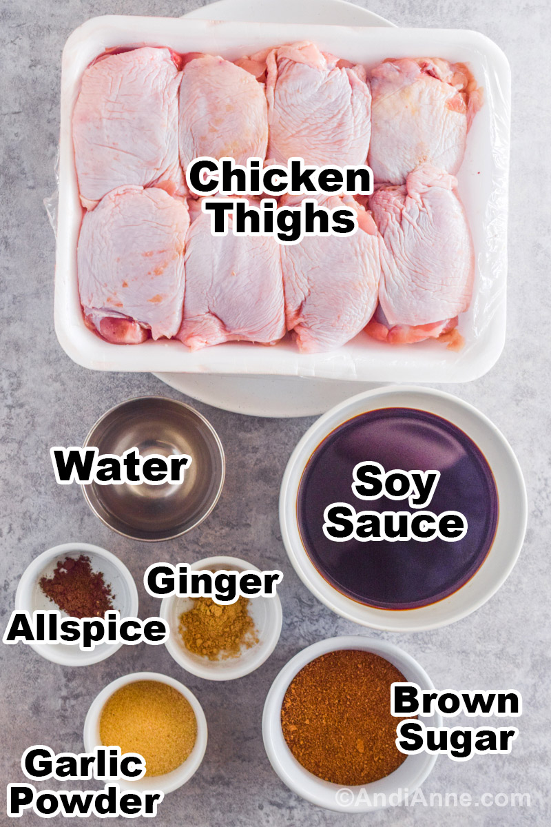 Recipe ingredients on the counter including 8 raw chicken thighs in styrofoam container, bowls of soy sauce, water, allspice, ginger, garlic powder, and brown sugar.