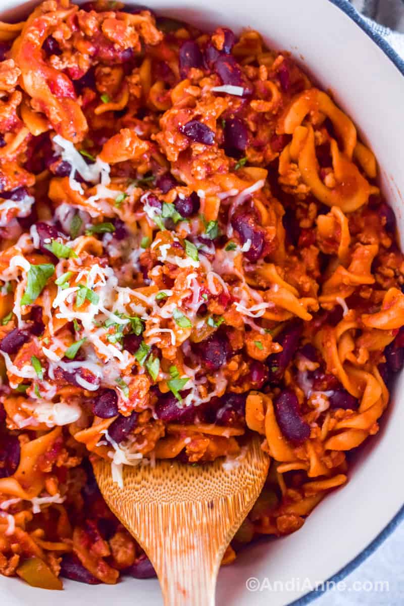 Close up of ground pork noodle pasta with kidney beans and sprinkled with mozzarella cheese.