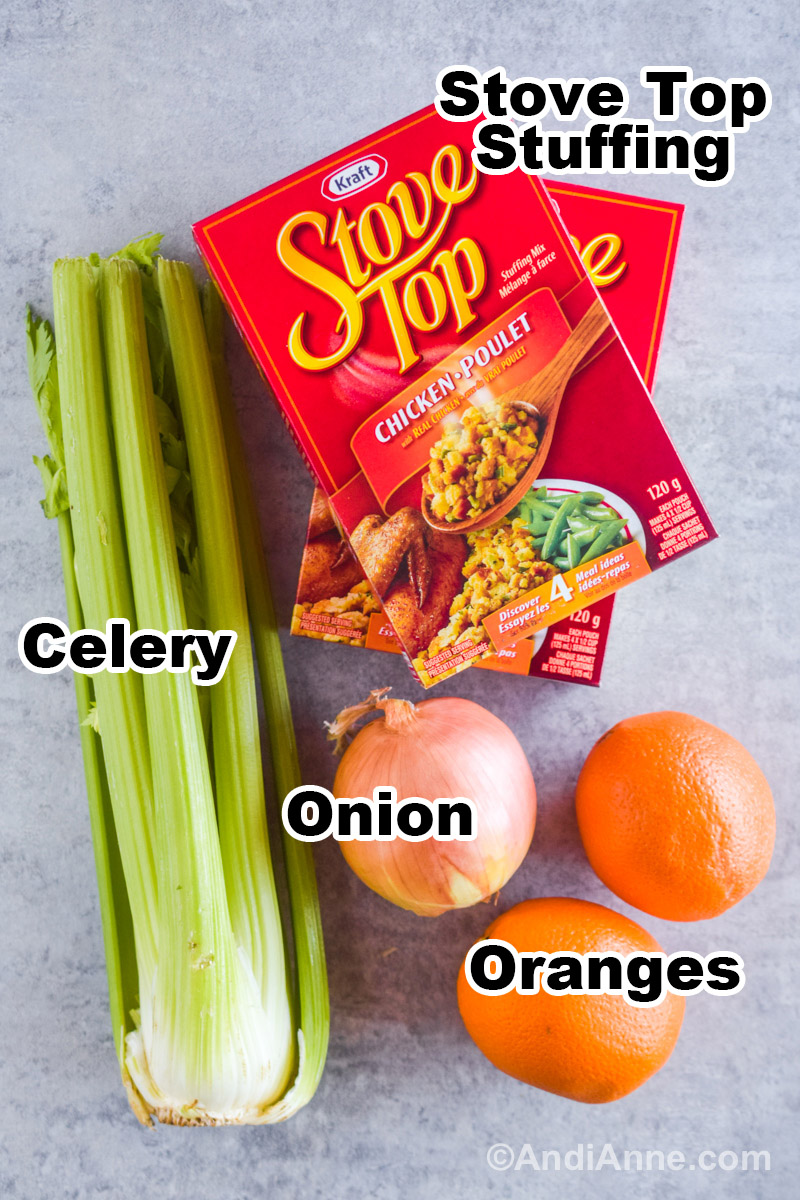 Recipe ingredients on the counter including boxes of stuffing, celery, yellow onion, and two navel oranges.