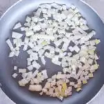 Chopped onion in a frying pan.