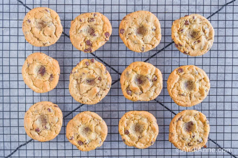 Chocolate chip cookies on a rack with indents in the center.