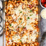 Baked tortellini casserole topped with melted cheese