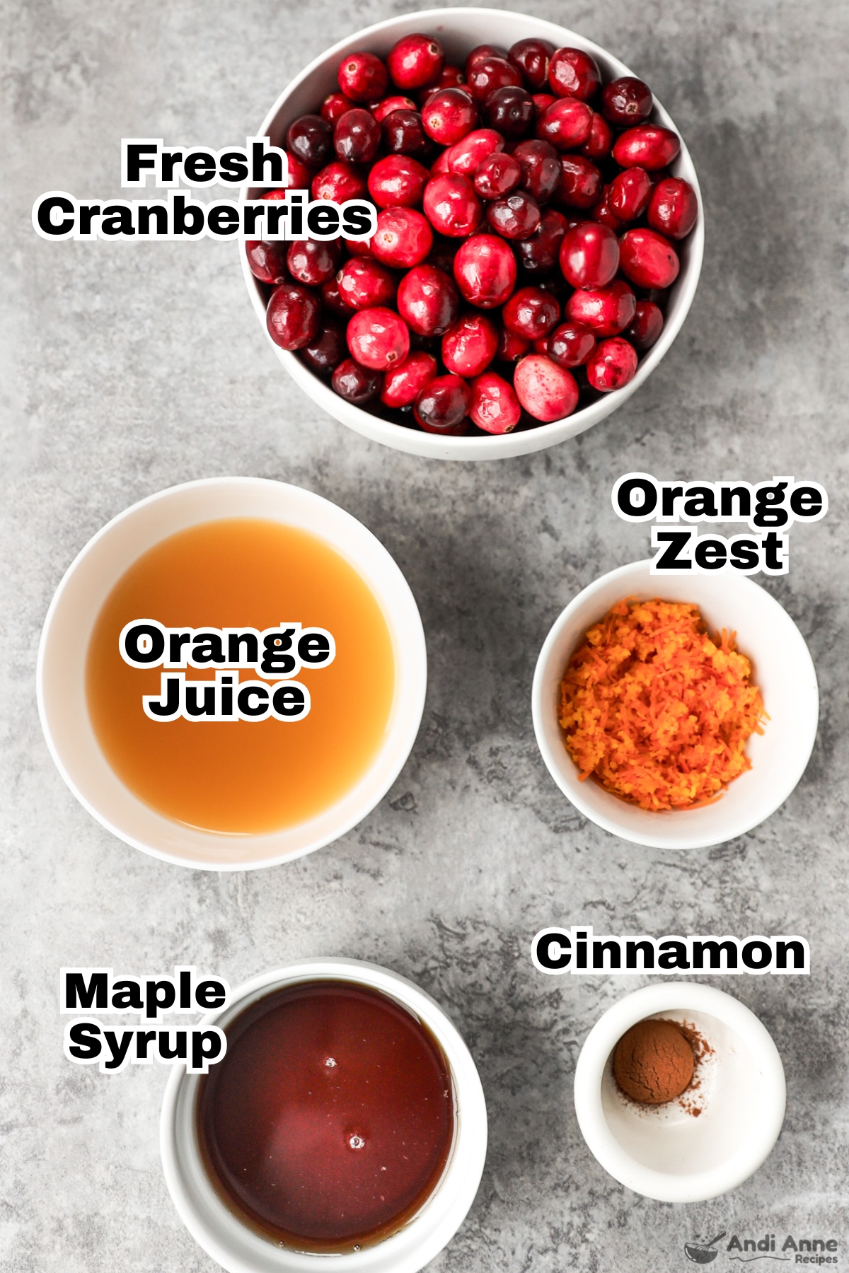 Recipe ingredients in bowls including fresh cranberries, orange juice, orange zest, maple syrup and cinnamon