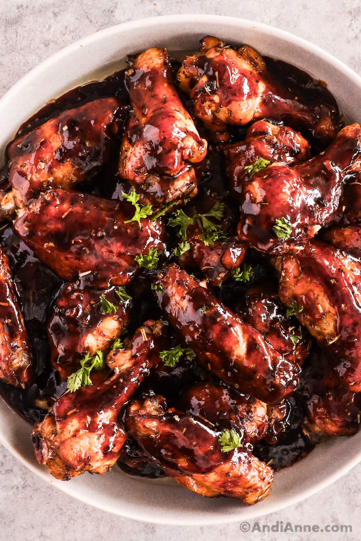 Close up of gooey saucy chicken wings
