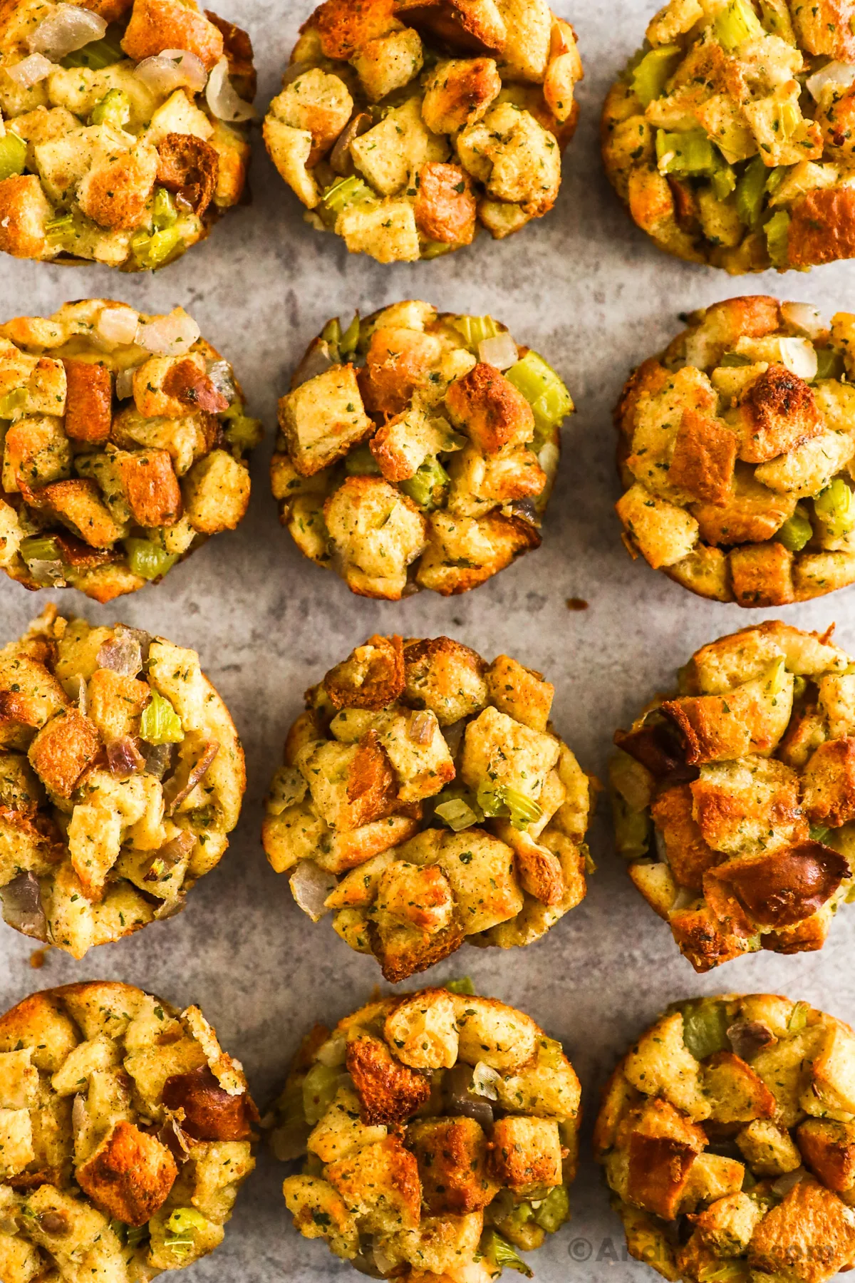 Looking down at cooked stuffing muffins on a counter.