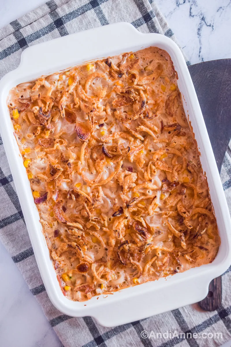 Ultimate chicken casserole in a white dish with a plaid kitchen towel underneath.