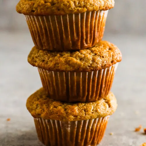 Three banana bread muffins sitting on top of eachother.
