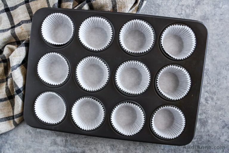 A muffin pan with paper liners inside.