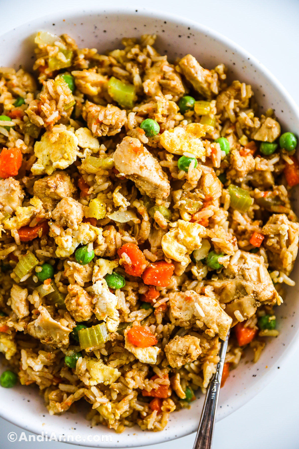Close up of chicken fried rice in a bowl.