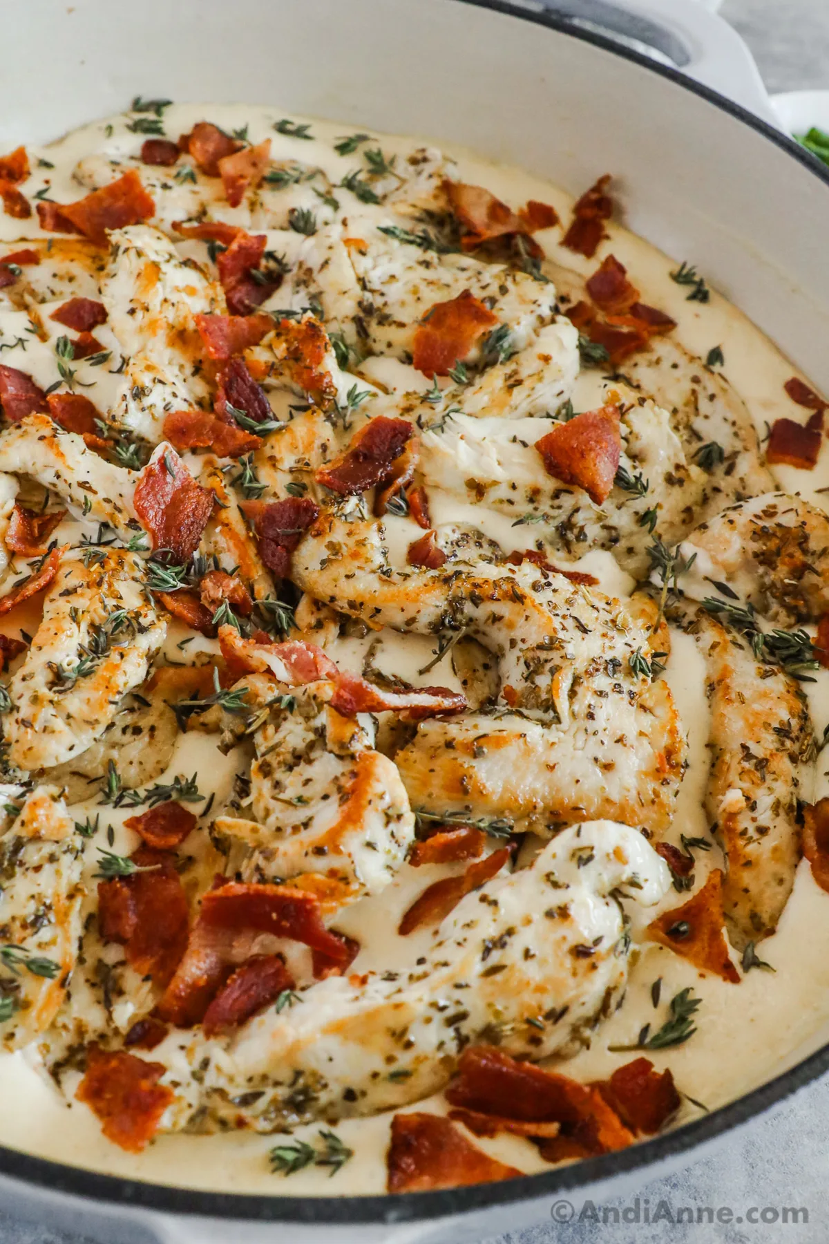 Close up of creamy ranch bacon thyme chicken recipe in a pan.