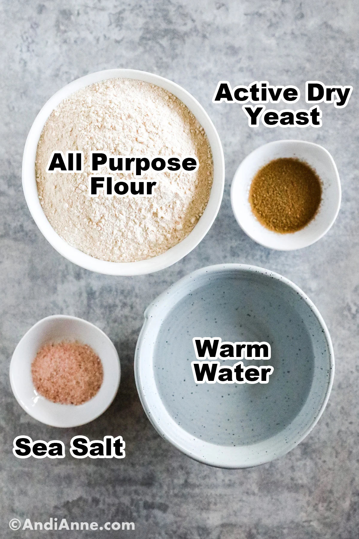Four ingredients in bowls including all purpose flour, yeast, sea salt and warm water.