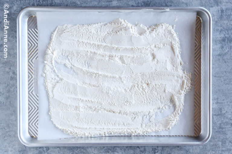 A baking sheet with flour sprinkled on top.