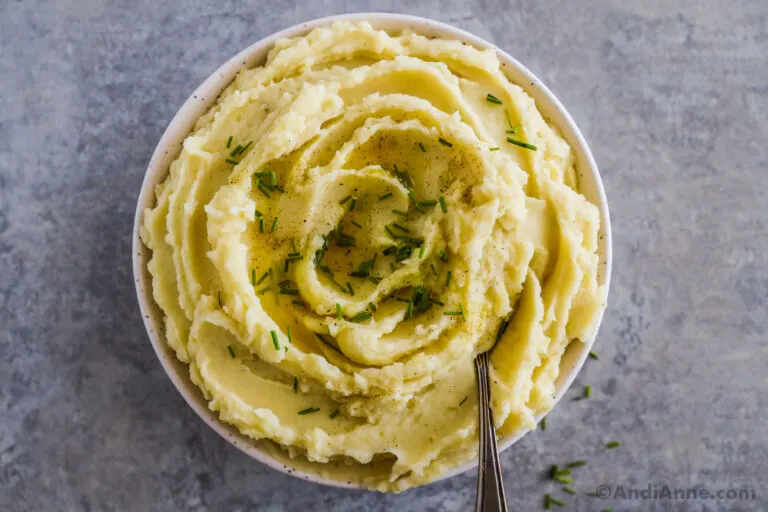 A bowl of plant based mashed potatoes topped with chopped chives.