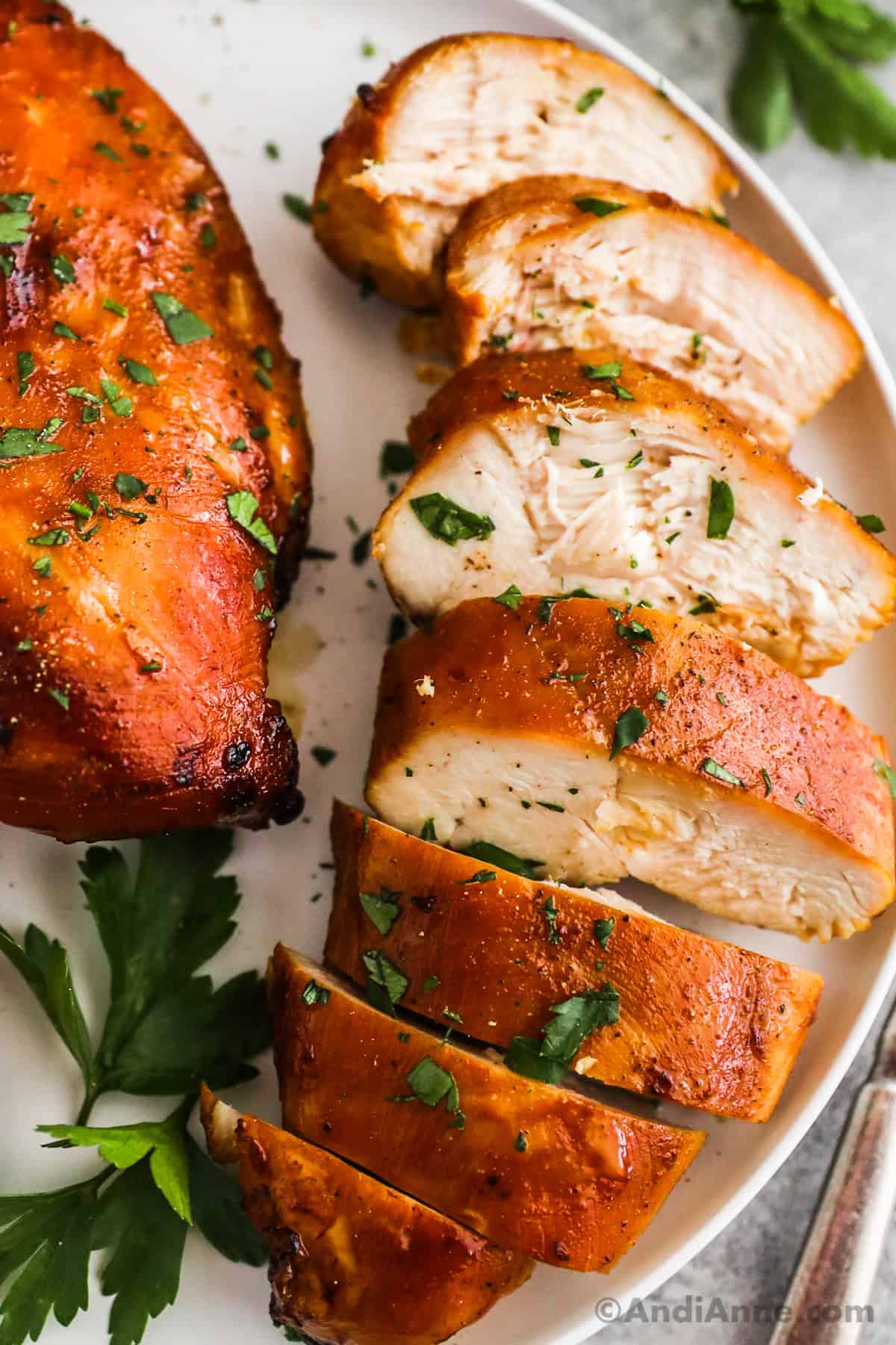 Close up of a sliced chicken breast with soy sauce coating.