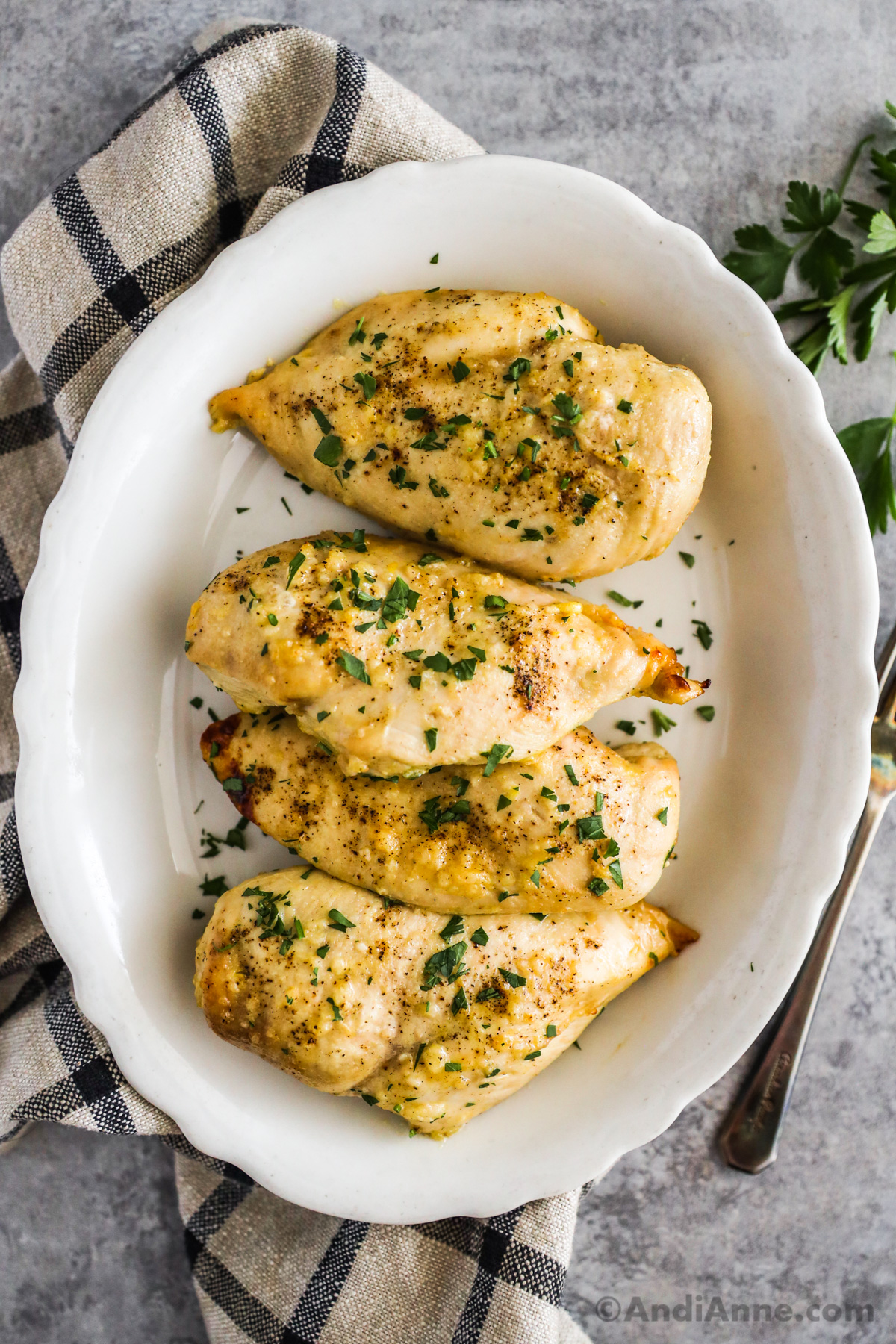 Baked honey mustard chicken breasts topped with parsley garnish.