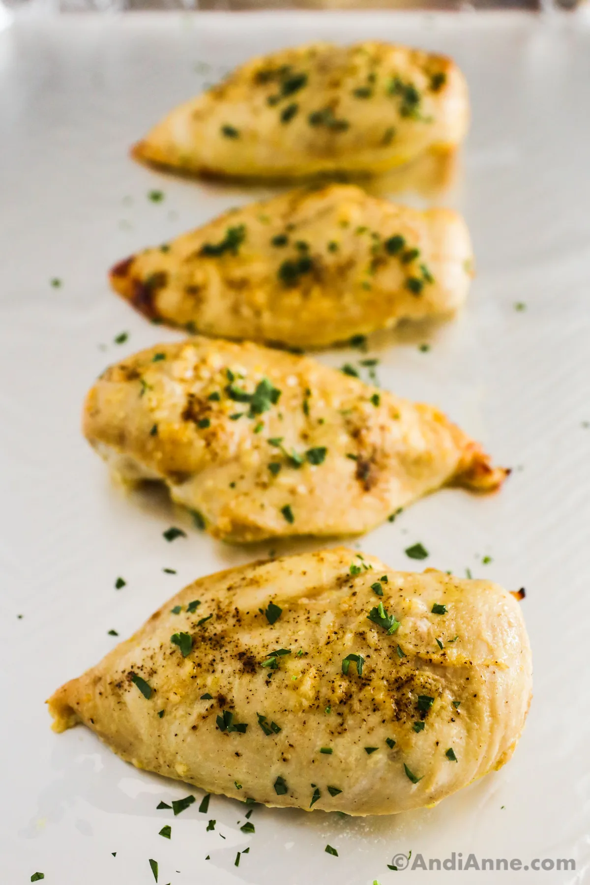 Baked chicken breasts on a baking sheet.