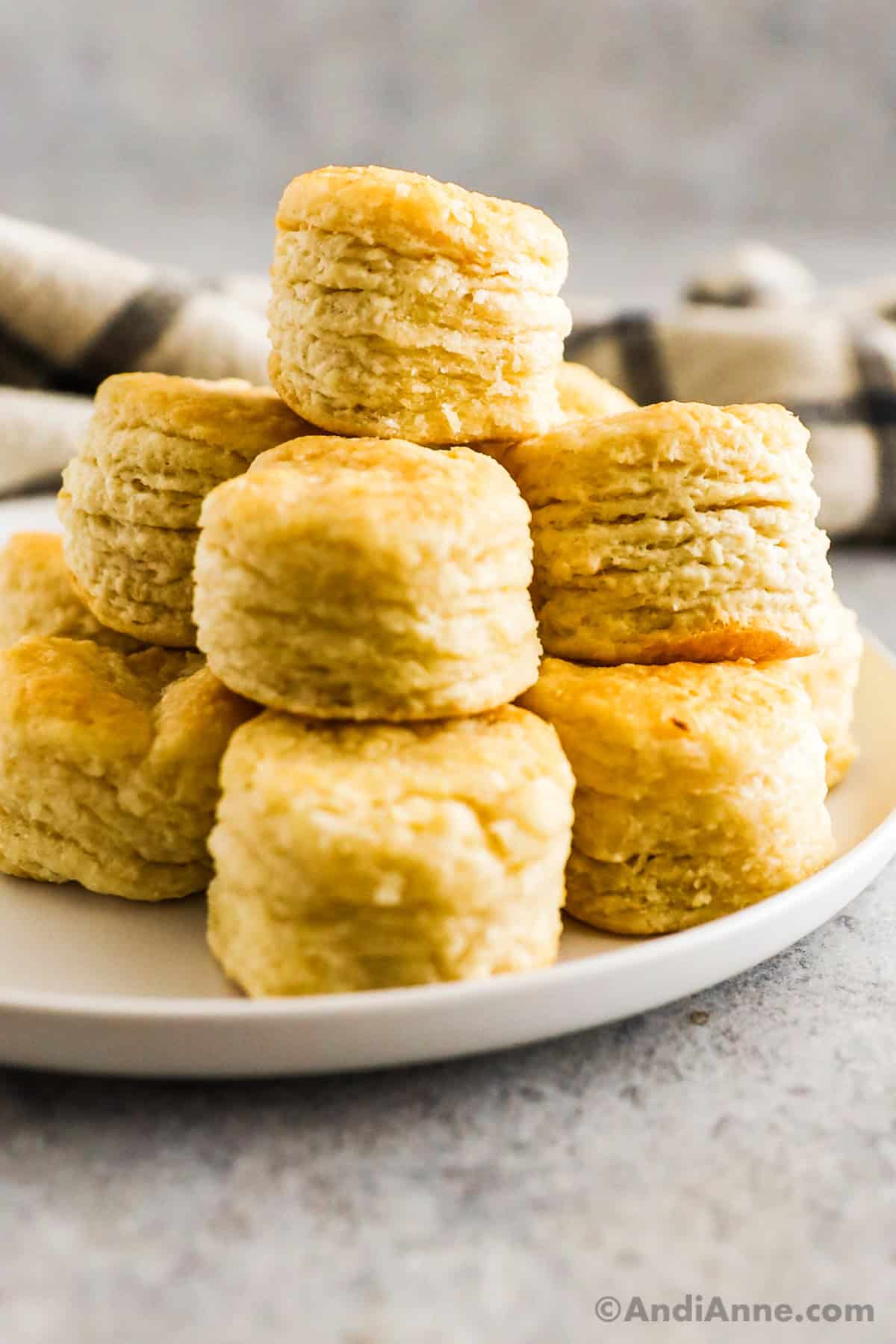 A stack of baking powder biscuits on a white plate.