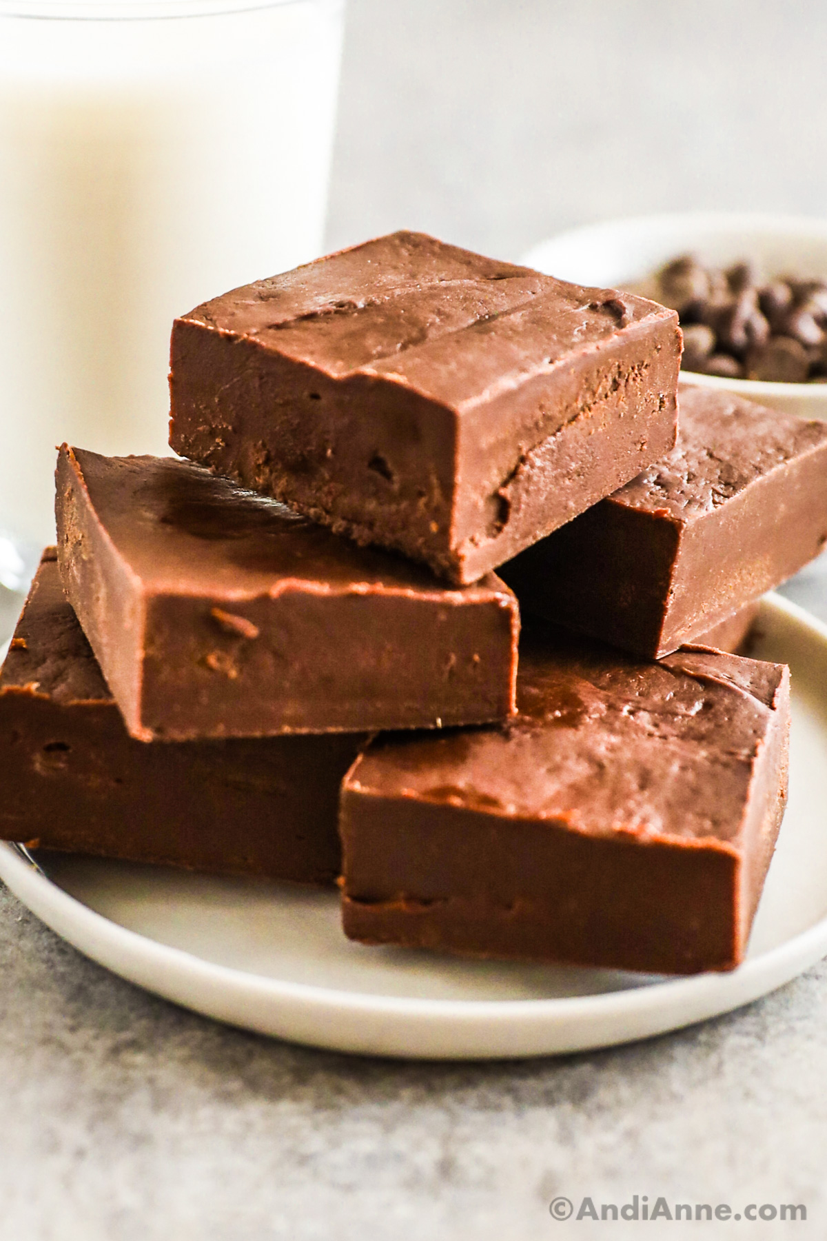 A stack of chocolate fudge squares on a plate.