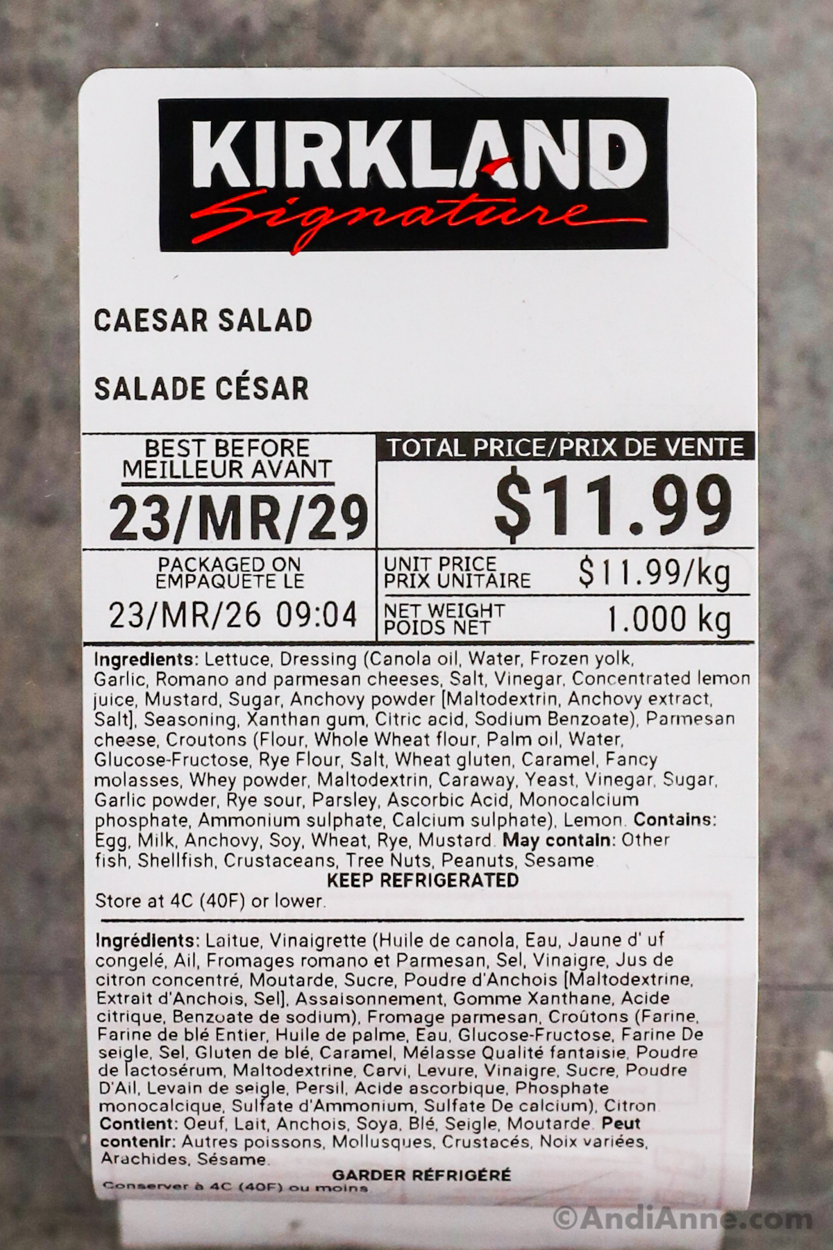 Close up of a kirkland signature caesar salad label with price, recipe ingredients and best before date.