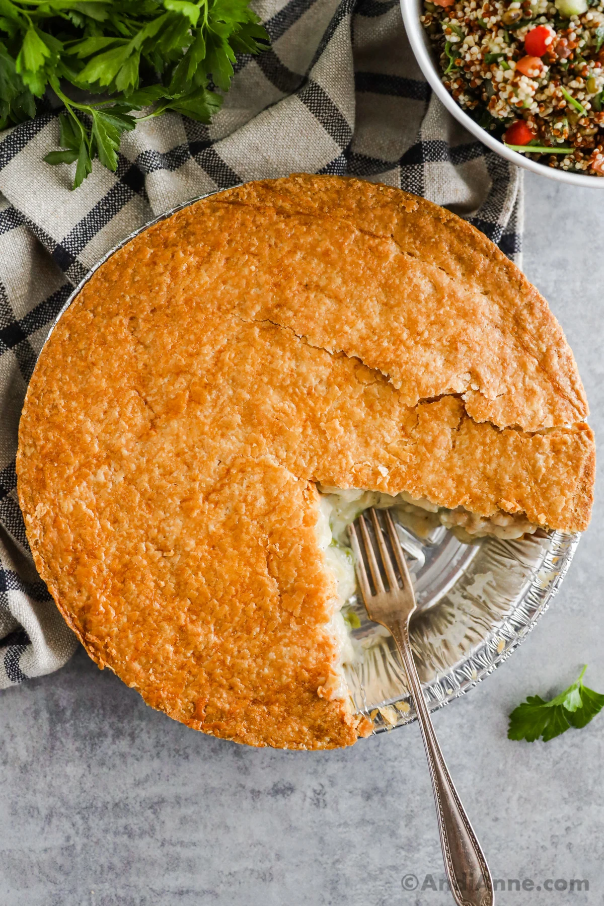 A slice cut out of costco chicken pot pie with a fork in its place. 