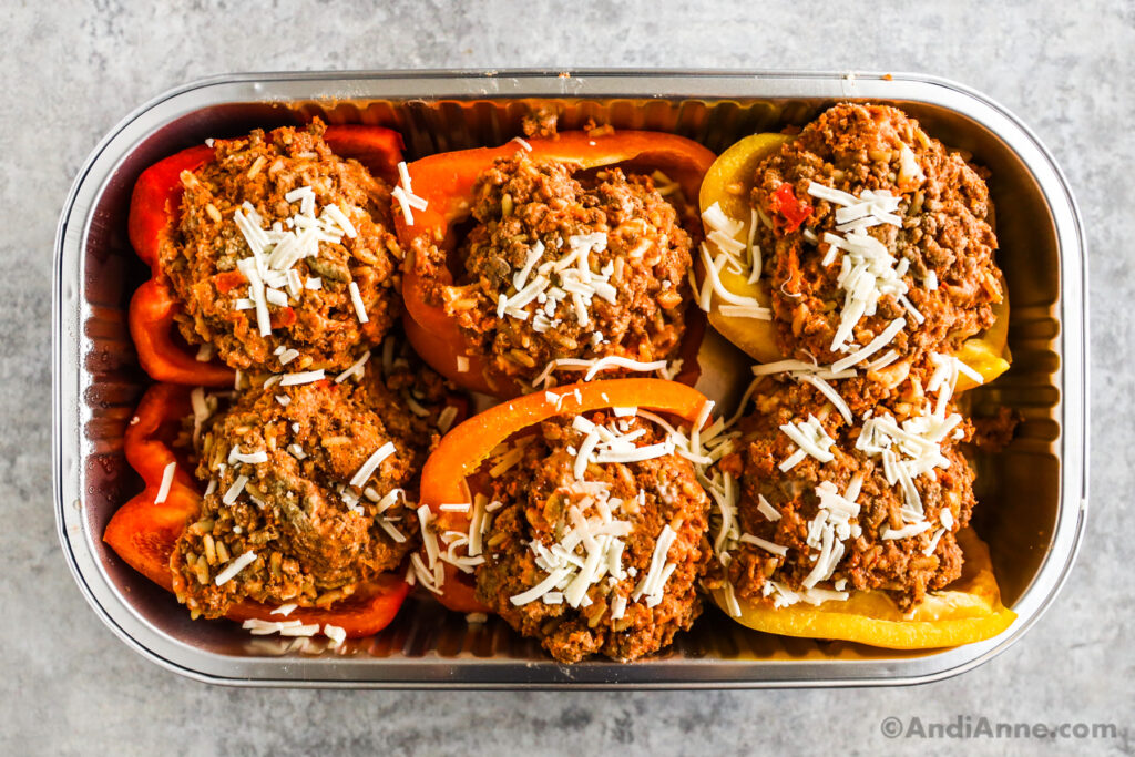 Unbaked Costco stuffed bell peppers in an aluminum foil tray.