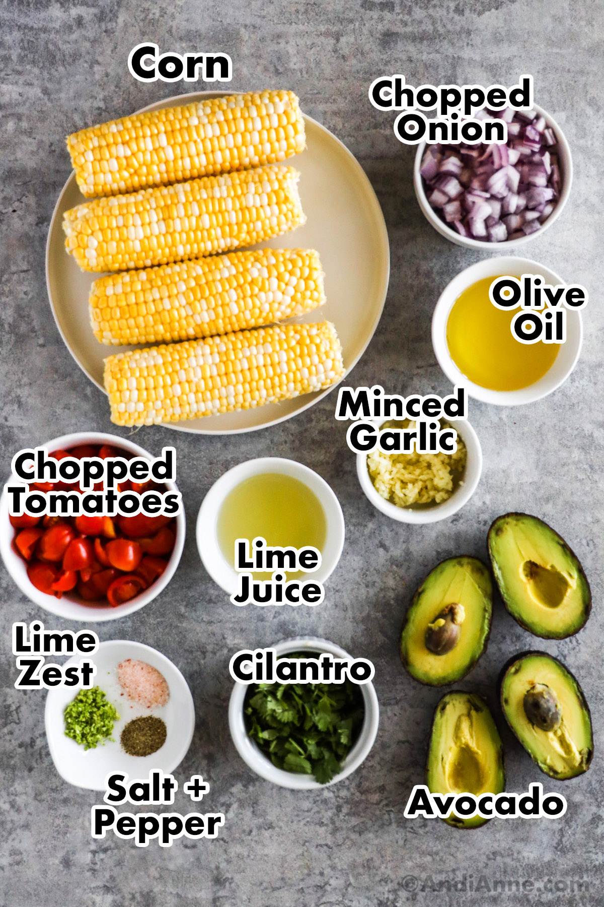Recipe ingredients in bowls including corn, bowls of chopped onion, olive oil, minced garlic, lime juice, chopped tomatoes, avocado, cilantro and spices.