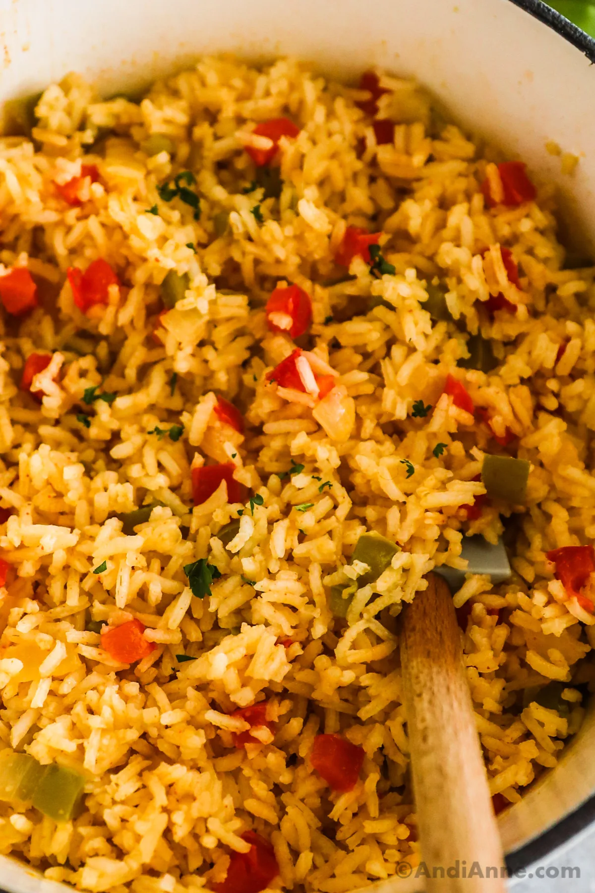 Close up of yellow cajun rice with chopped red and green bell peppers.  