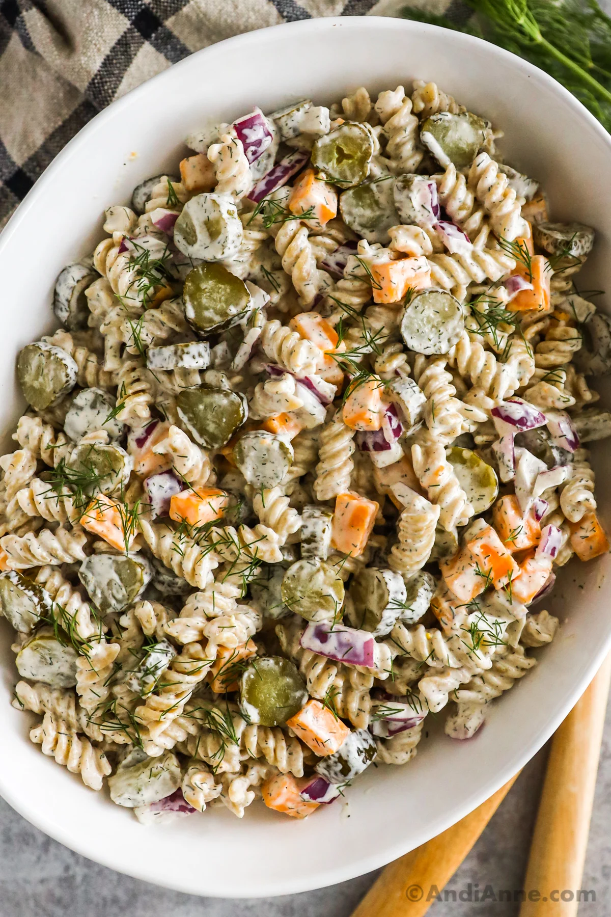 Dill pickle pasta salad in a large white bowl.