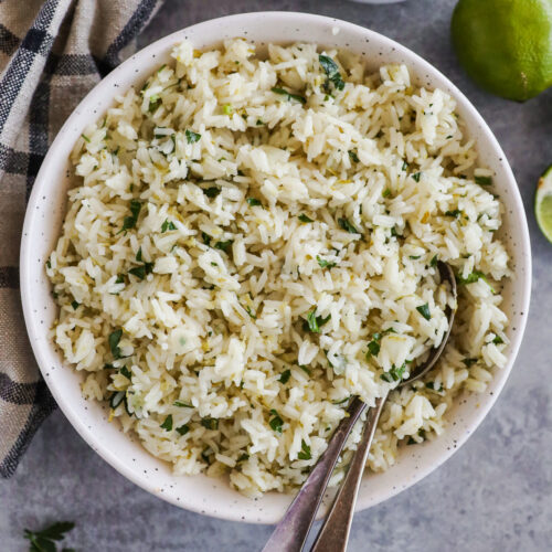 Cilantro lime rice in a bowl with spoons.