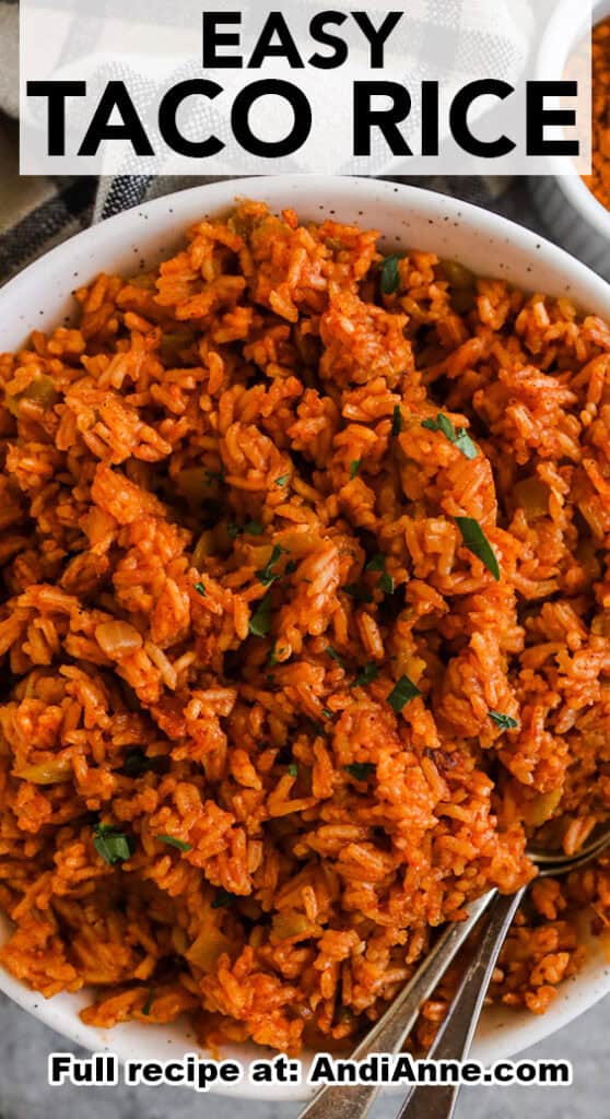 Easy taco rice in a white bowl with two spoons inside.