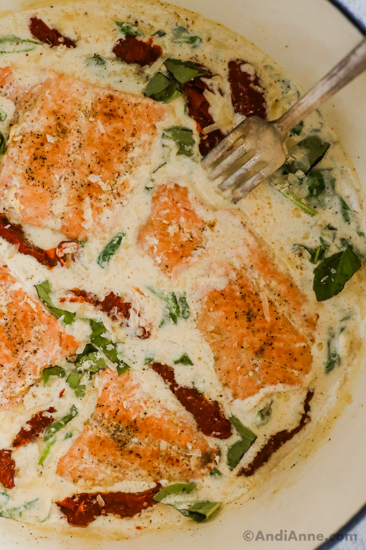 Details of creamy tuscan salmon with spinach, basil, and sun dried tomatoes. 