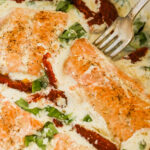 Creamy tuscan salmon recipe with sun dried tomatoes and spinach.
