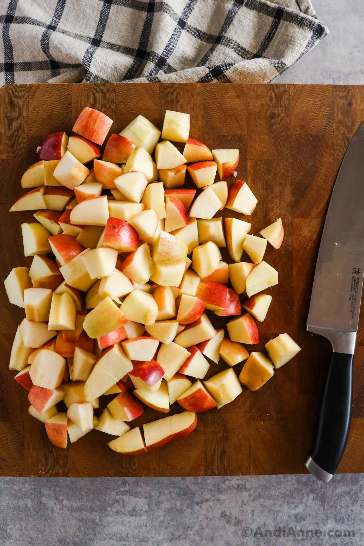 Chopped apples on a cutting board with a knife.