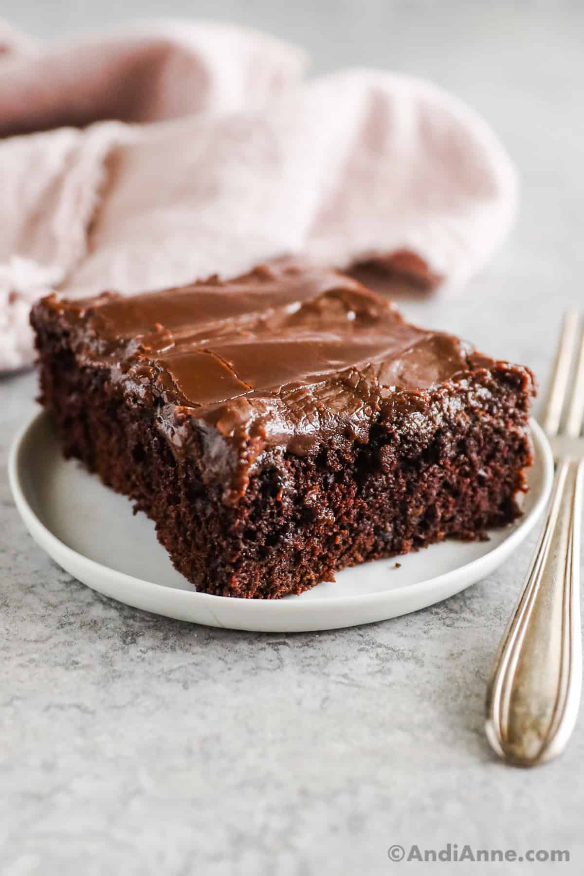 A slice of of chocolate wacky cake on a plate.