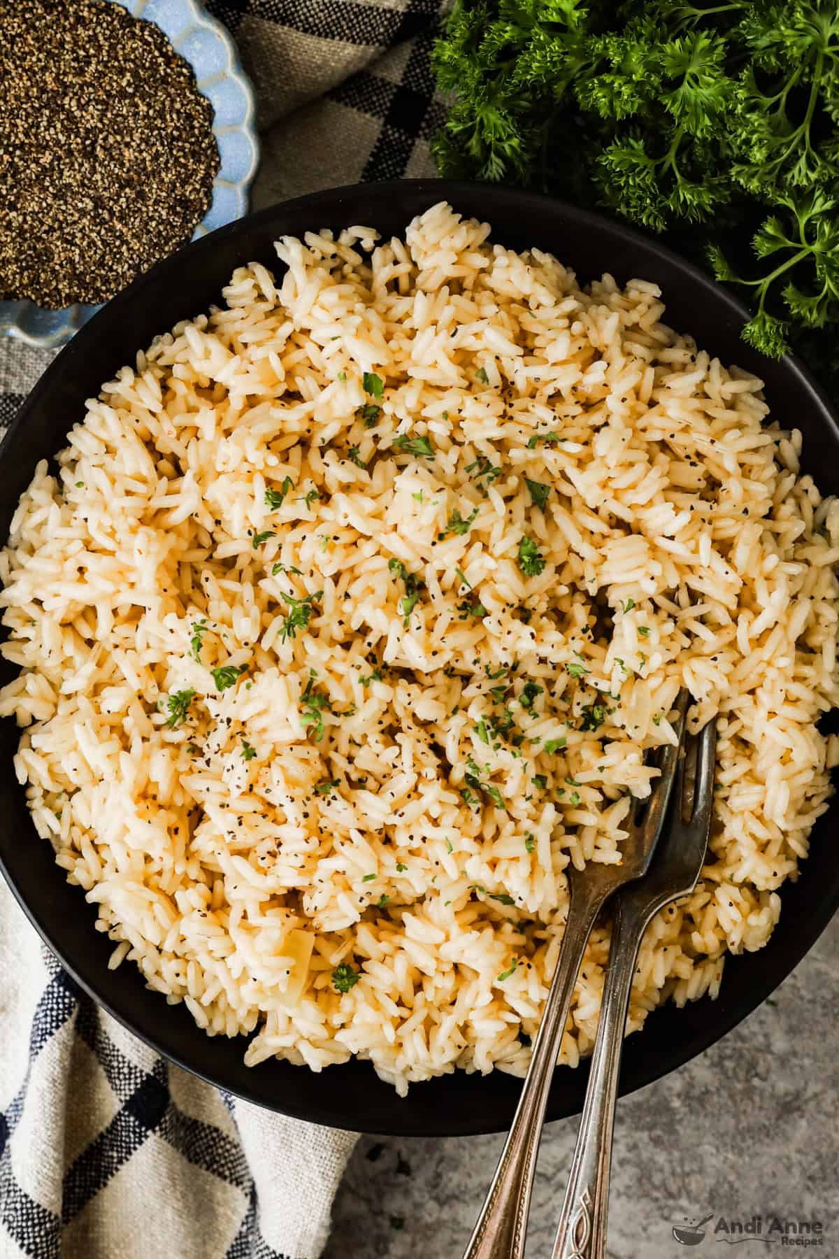 a plate of garlic butter rice with two forks