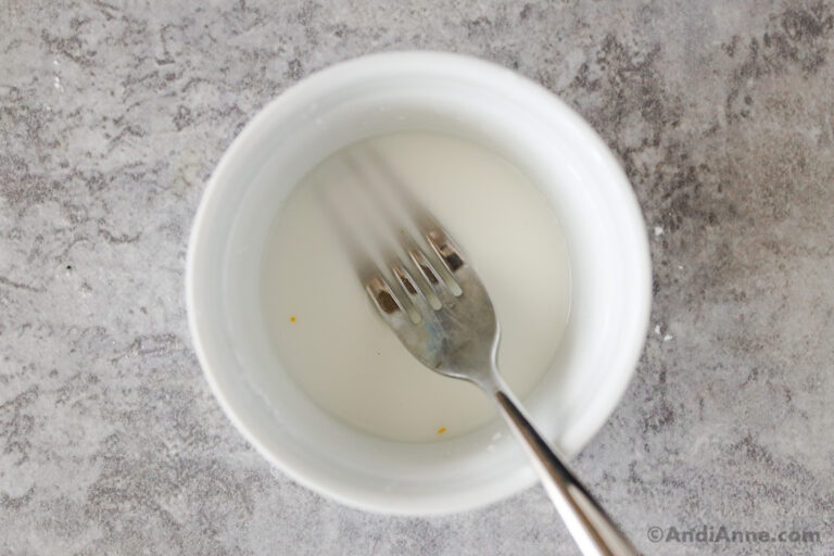 A small bowl with water and cornstarch and a fork.