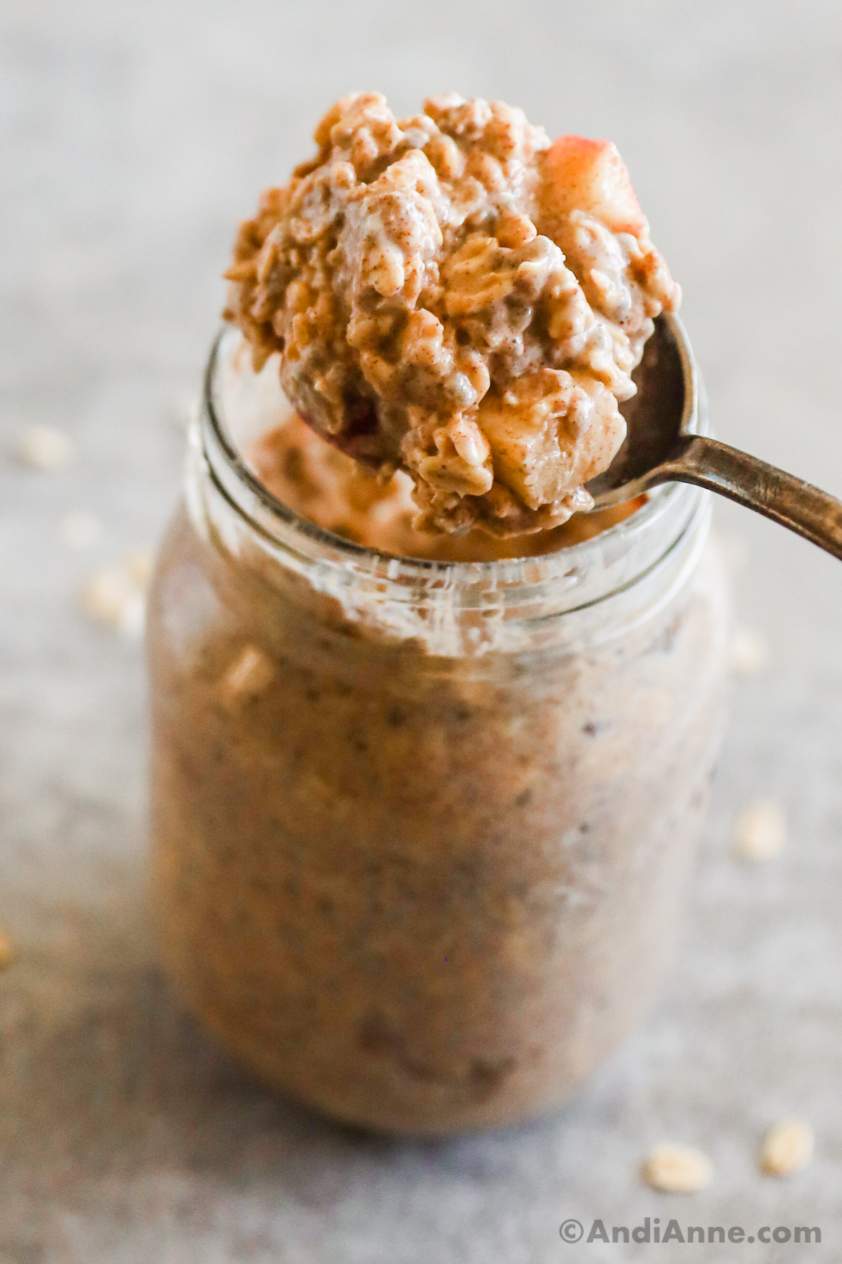 A spoonful close up of apple cinnamon overnight oats.