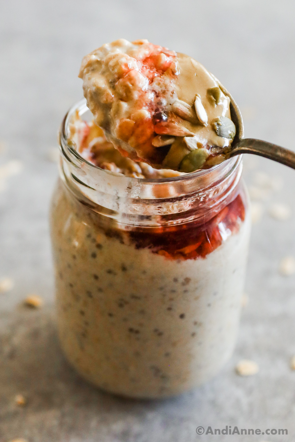 A spoonful of peanut butter overnight oats out of a mason jar.
