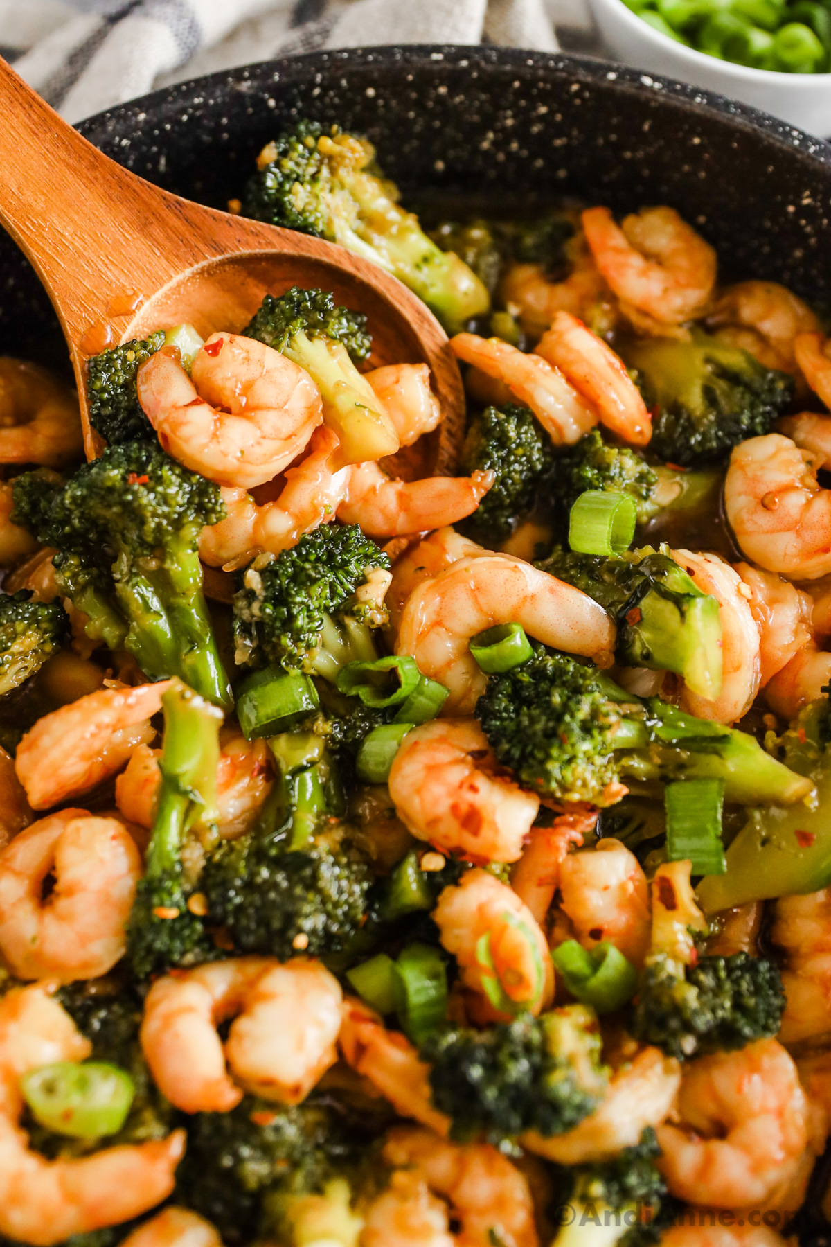 Close up of shrimp, broccoli and chopped green onion.