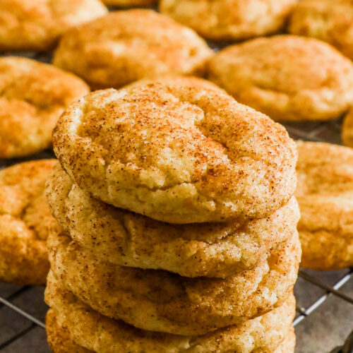 A stack of snickerdoodle cookies with more behind it.
