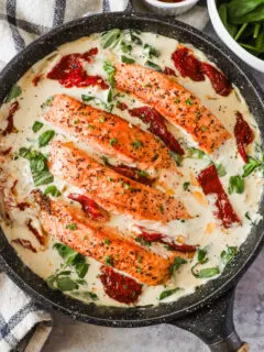 Tuscan salmon recipe in a frying pan with creamy sauce