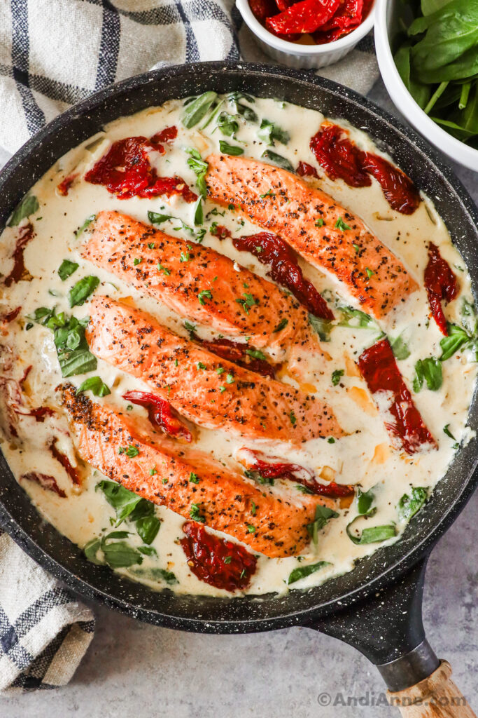 Tuscan salmon recipe in a frying pan with creamy sauce