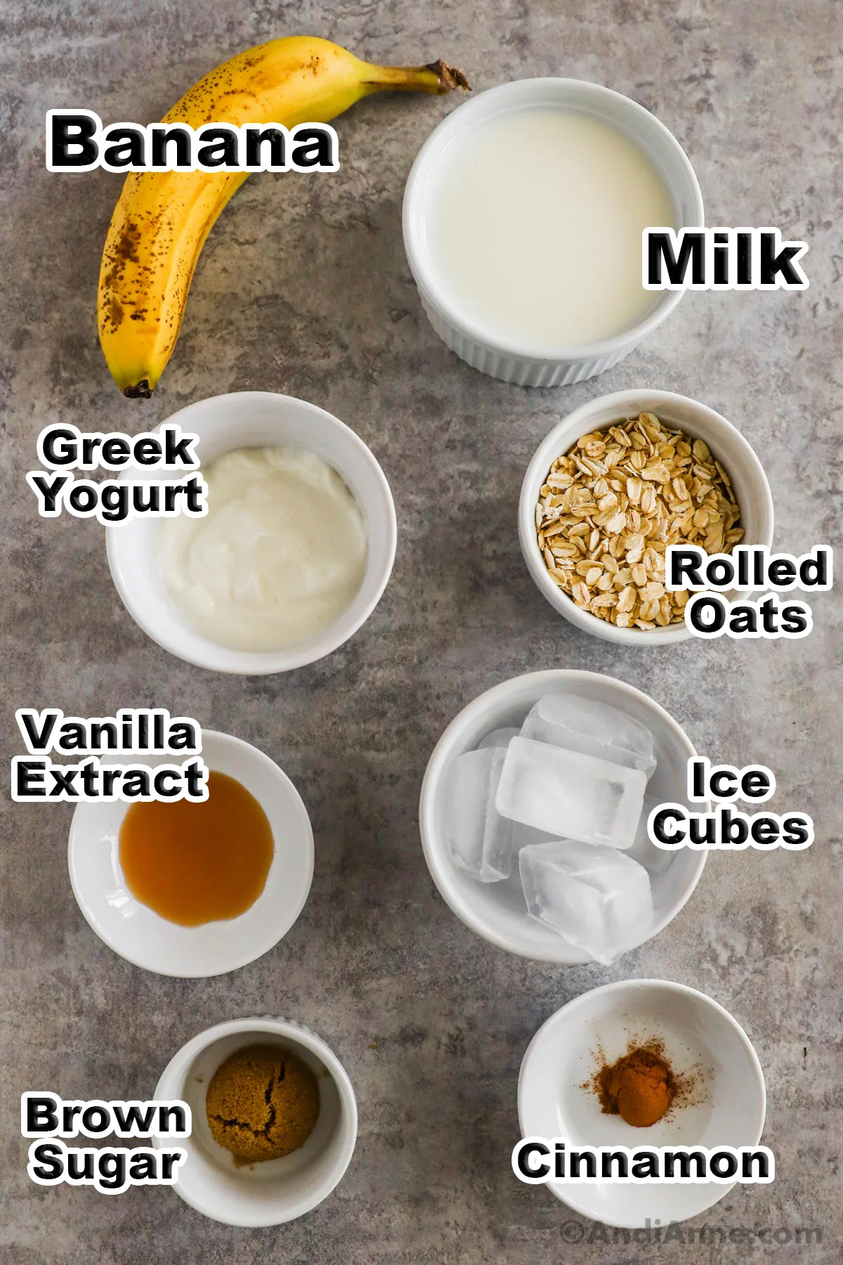 Bowls of milk, yogurt, oats, ice cubes, vanilla extract, brown sugar and cinnamon. Also a banana.