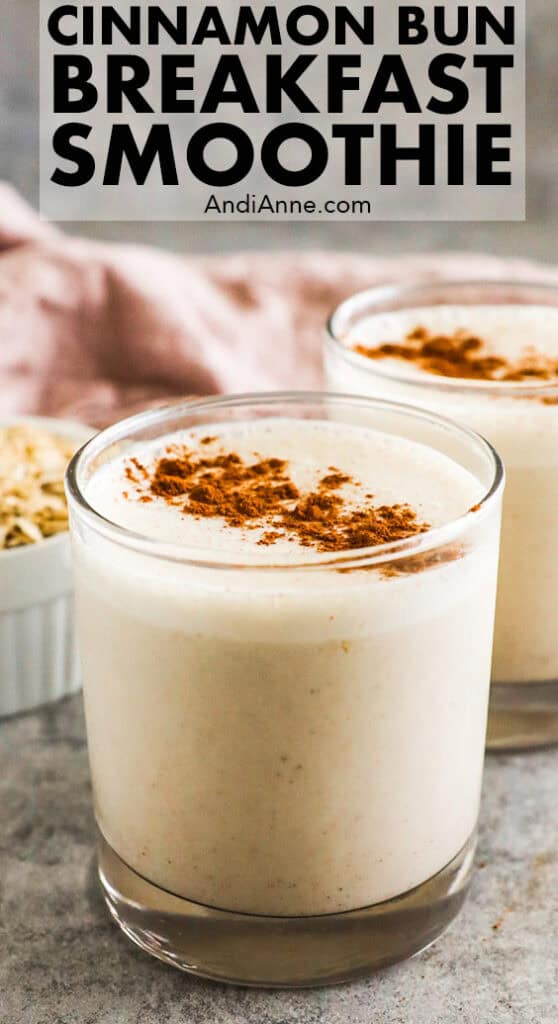 A glass of cinnamon bun breakfast smoothie sprinkled on the top with cinnamon.