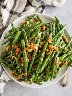 Garlic Parmesan green beans with crunchy bread crumbs on a plate.