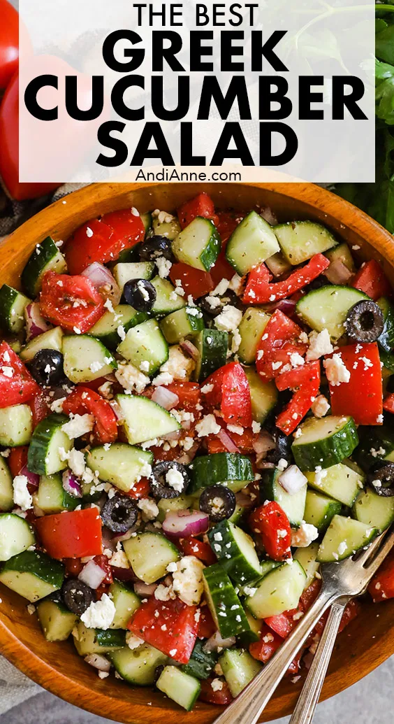 Greek cucumber salad in a bowl with tomatoes, olives, onion and feta cheese.