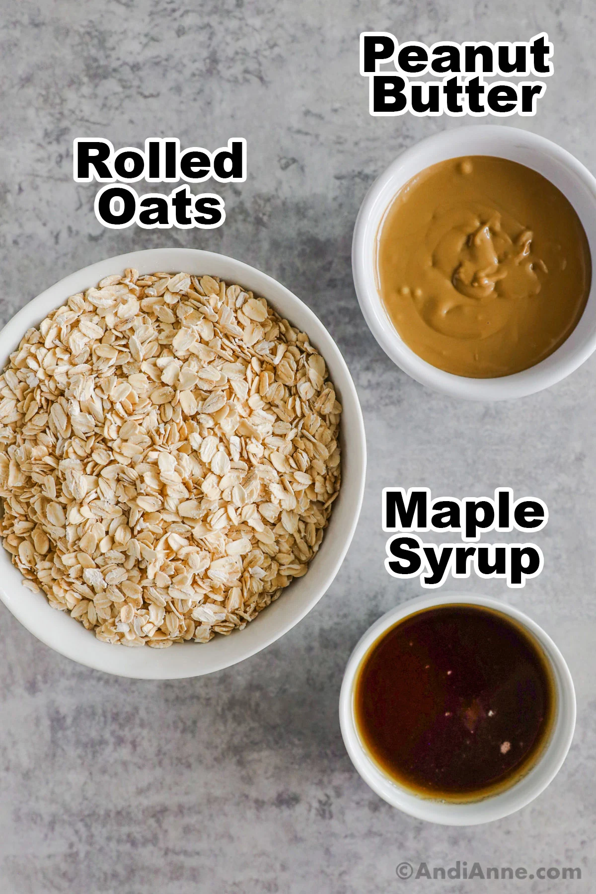 Bowls of rolled oats, peanut butter and maple syrup.