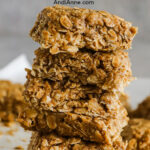 A stack of no bake peanut butter oatmeal bars on top of eachother.